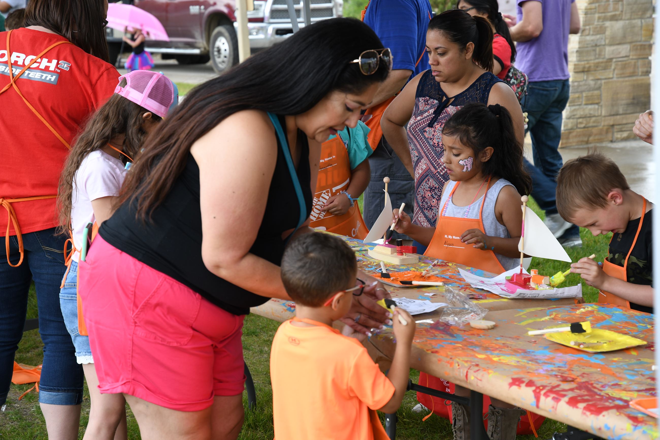 Mother helping toddler with summerfest activity