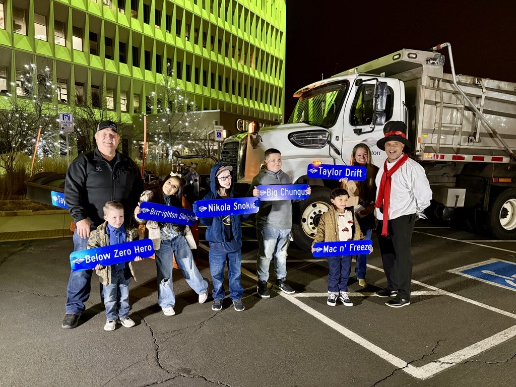 Snowplow Contest winners in front of snowplow