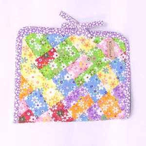 Handmade patchwork bag with greens, blues, reds, purples, and oranges.