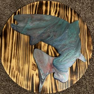 Resin fish design on a wooden circular plate. 